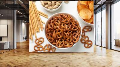 Delicious pretzel crackers and other snacks on white table, flat lay Wall mural