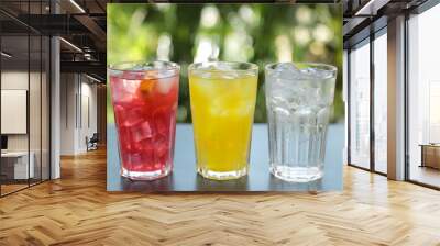 Delicious refreshing drinks in glasses on grey table outdoors Wall mural