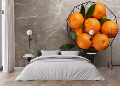 Delicious ripe oranges in fruit bowl on grey marble table, flat lay. Space for text Wall mural