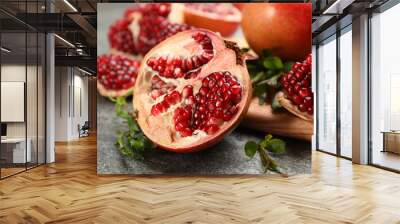 Delicious ripe pomegranates on grey table, closeup Wall mural