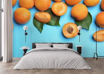 Delicious ripe sweet apricots on blue background, flat lay. Space for text Wall mural