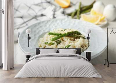 Delicious risotto with asparagus on white wooden table, closeup Wall mural