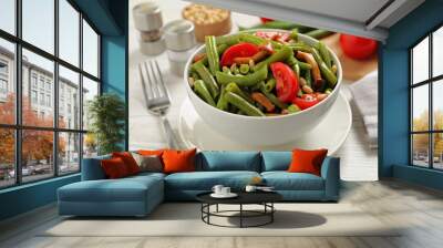 Delicious salad with green beans, mushrooms, pine nuts and tomatoes served on white wooden table Wall mural