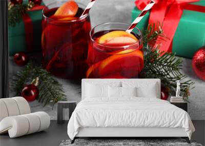 Delicious Sangria drink in glasses and Christmas decorations on grey textured table, closeup Wall mural