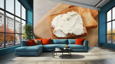 Delicious toasted bread slices with cream cheese on grey table, closeup Wall mural