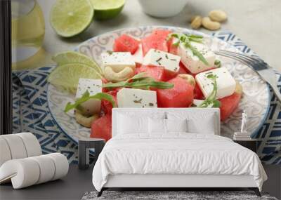 Delicious watermelon salad with feta cheese, cashew nuts and spices served on light table, closeup Wall mural