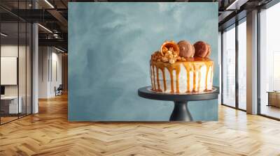 Dessert stand with delicious caramel cake on color background Wall mural