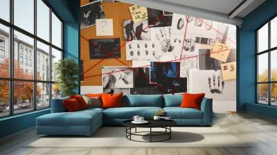 Detective board with crime scene photos, stickers, clues and red thread, closeup Wall mural