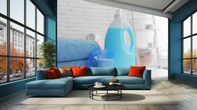 Detergents and clean towels on table indoors, space for text. Laundry day Wall mural