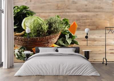 Different fresh herbs, cabbages and pumpkin on wooden table, space for text Wall mural