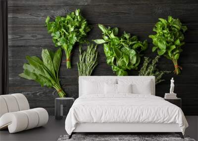 Different fresh herbs on wooden table, top view Wall mural