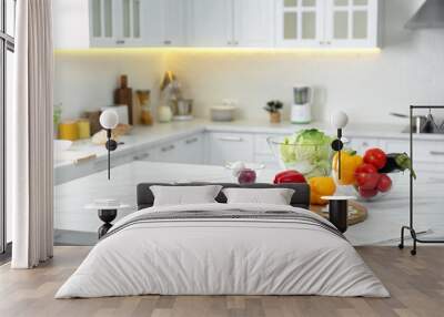 Different fresh vegetables and mushrooms on white table in modern kitchen. Space for text Wall mural