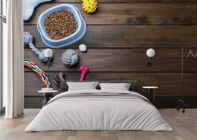 Different pet toys and feeding bowl on wooden background, flat lay. Space for text Wall mural