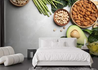 Different products rich in vitamin E on grey marble table, flat lay. Space for text Wall mural