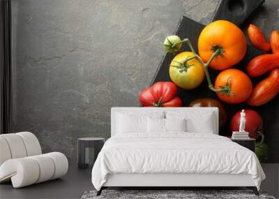 Different ripe tomatoes on grey table, top view. Space for text Wall mural