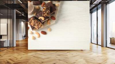 Different tasty energy bars, nuts and protein powder on white wooden table, flat lay Space for text Wall mural