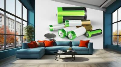 Different types of batteries on light background Wall mural