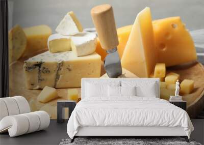 Different types of delicious cheese in wooden plate, closeup Wall mural