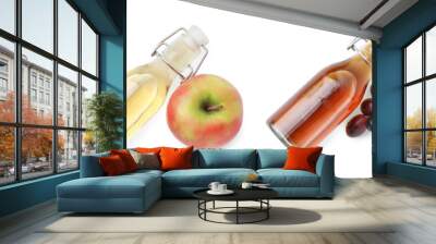 Different types of vinegar in glass bottles isolated on white, top view Wall mural