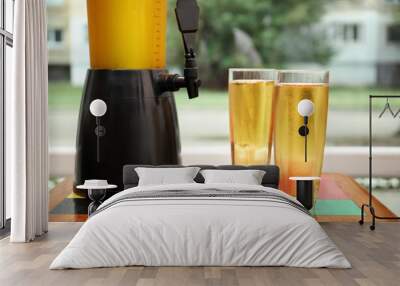 Dispenser and glasses with cold beer on table Wall mural