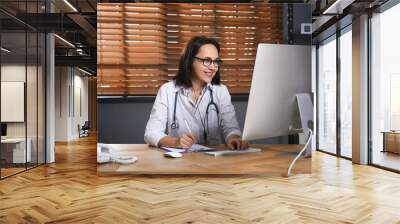 Doctor with headset and computer consulting patient online in office. Hotline service Wall mural