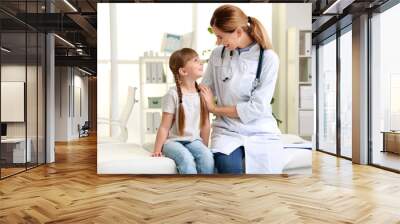 Doctor working with little patient in hospital Wall mural