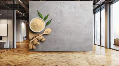 Dry ginger powder, fresh root and leaves on grey table, flat lay. Space for text Wall mural