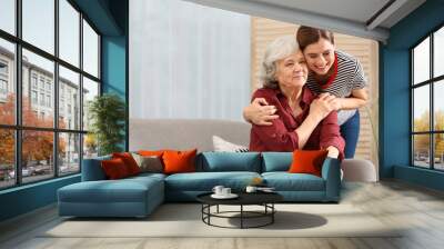 Elderly woman with female caregiver in living room. Space for text Wall mural