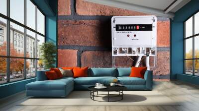 Electric meter on red brick wall, space for text. Energy measuring device Wall mural