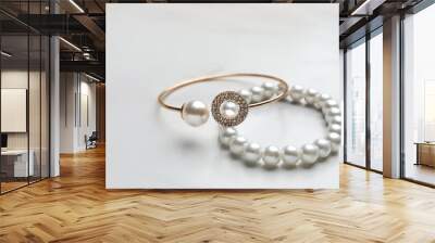 Elegant bracelets with pearls on white marble table, closeup Wall mural