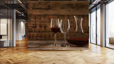 Elegant decanter with red wine and glasses on wooden table Wall mural