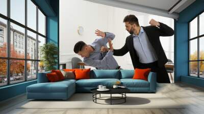 Emotional colleagues fighting in office. Workplace conflict Wall mural