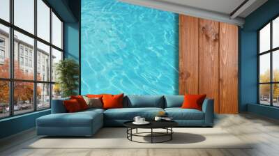 Empty wooden surface near swimming pool with clear water. Space for design Wall mural