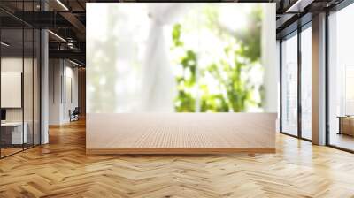 Empty wooden table in front of window. Sunny morning Wall mural