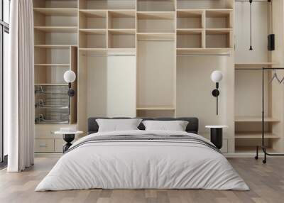 Empty wooden wardrobe with shelves and drawers in dressing room Wall mural