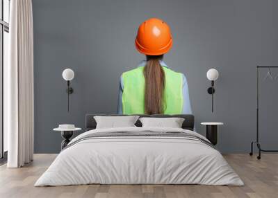 Engineer in hard hat on grey background, back view Wall mural