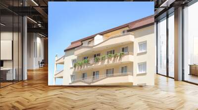 Exterior of beautiful residential building against blue sky Wall mural