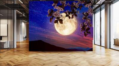 Fantasy night. Blossoming cherry tree branch and starry sky with full moon on background Wall mural