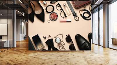 Fashionable male and female accessories on beige background, flat lay. Space for text Wall mural