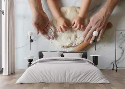 Father and child making dough at white table, top view Wall mural