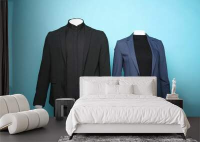 Female and male mannequins with stylish suits on light blue background Wall mural