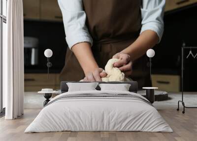 Female baker preparing bread dough at table, closeup Wall mural