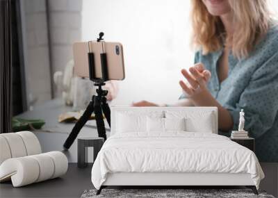 Female blogger recording video at table Wall mural