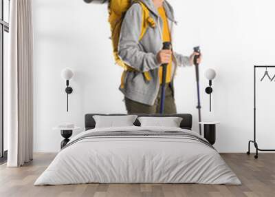 Female hiker with backpack and trekking poles on white background Wall mural