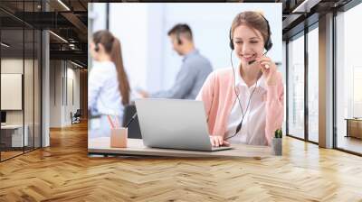 Female receptionist with headset at desk in office Wall mural