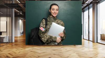 Female soldier with laptop and backpack near green chalkboard. Military education Wall mural