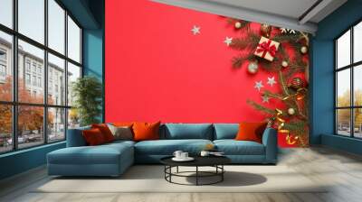 Fir branches with Christmas decoration on red background, flat lay. Space for text Wall mural