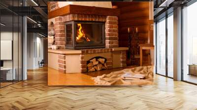 Fireplace with burning wood in room. Winter vacation Wall mural