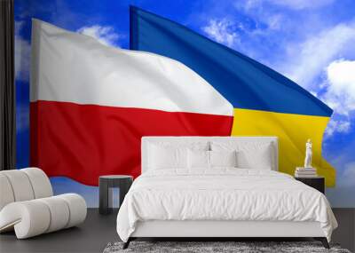 Flags of Poland and Ukraine against sky. Diplomatic international relations Wall mural