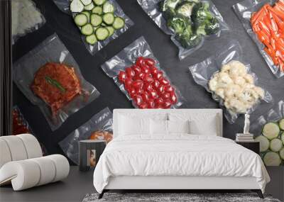 Flat lay composition of different food in vacuum packings on dark grey table Wall mural